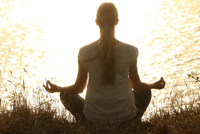 live online yoga session with instructor demonstrating posture on screen