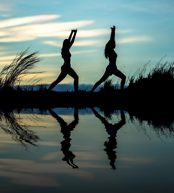 participant practicing gentle yoga stretches in a home environment following an online course